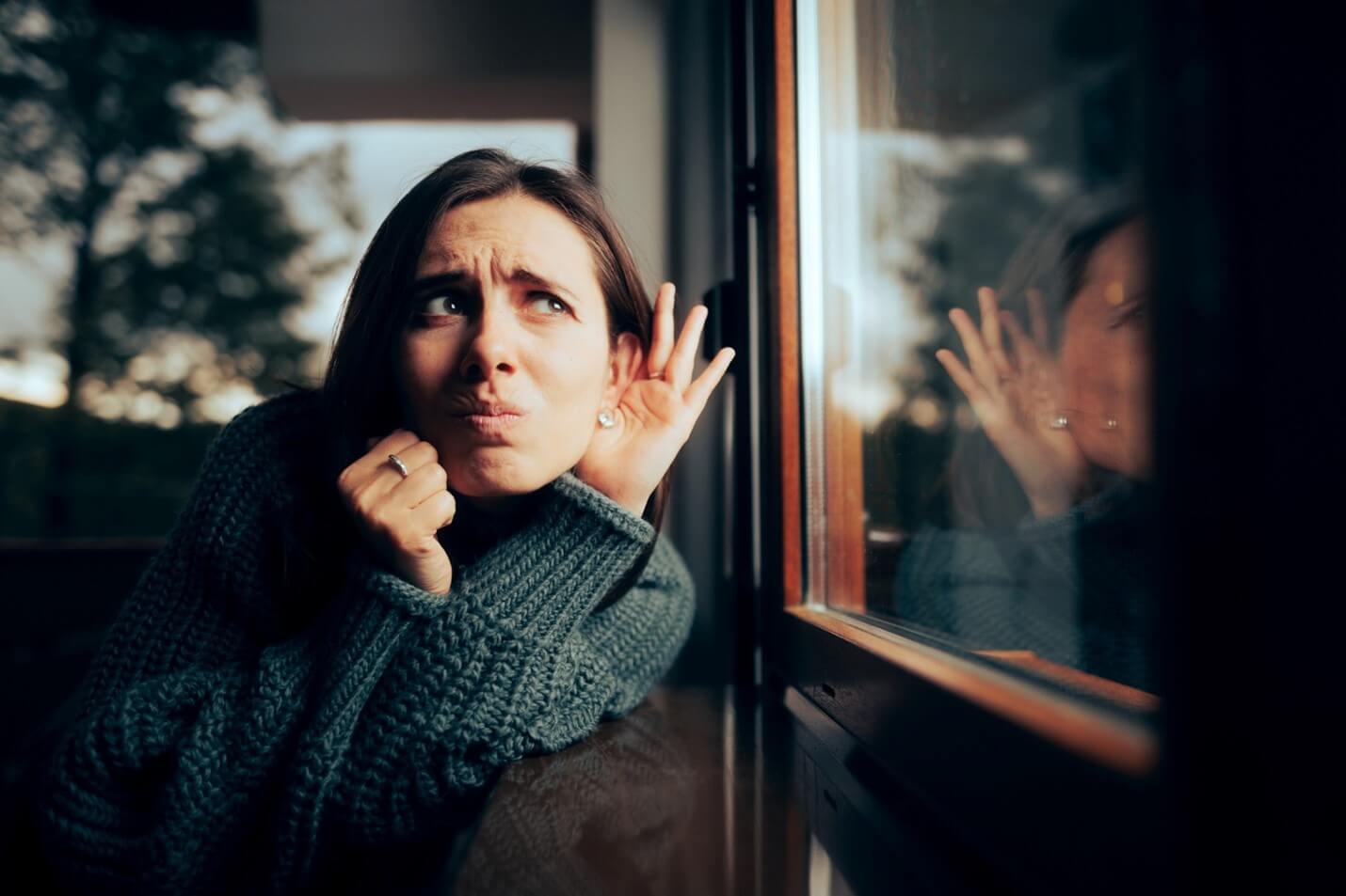 Woman Checking if the Windows are soundproof