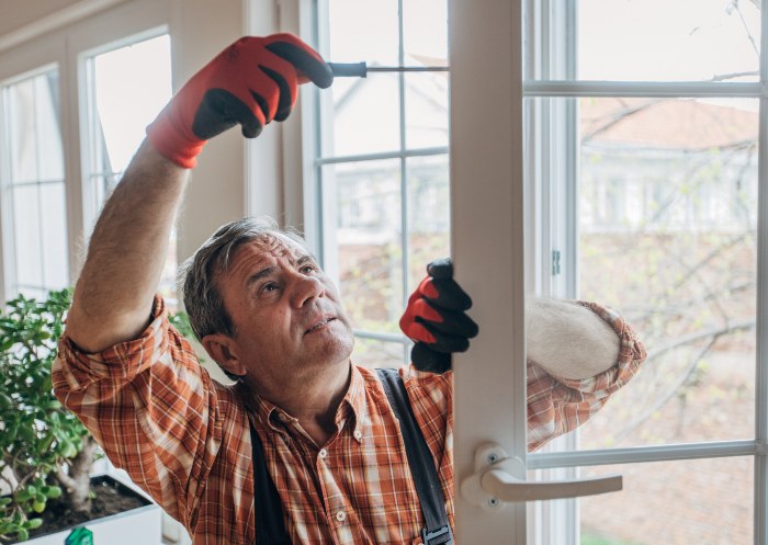 A worker installing energy efficient windows in Eastern IOWA