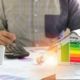 Man calculating cost savings and tax credit from energy efficient door and window