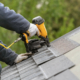 Person Working on a roof, inspecting roof material in Eastern Iowa